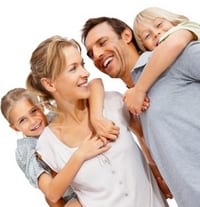 Portrait of a happy mature man and woman carrying kids on back at the beach